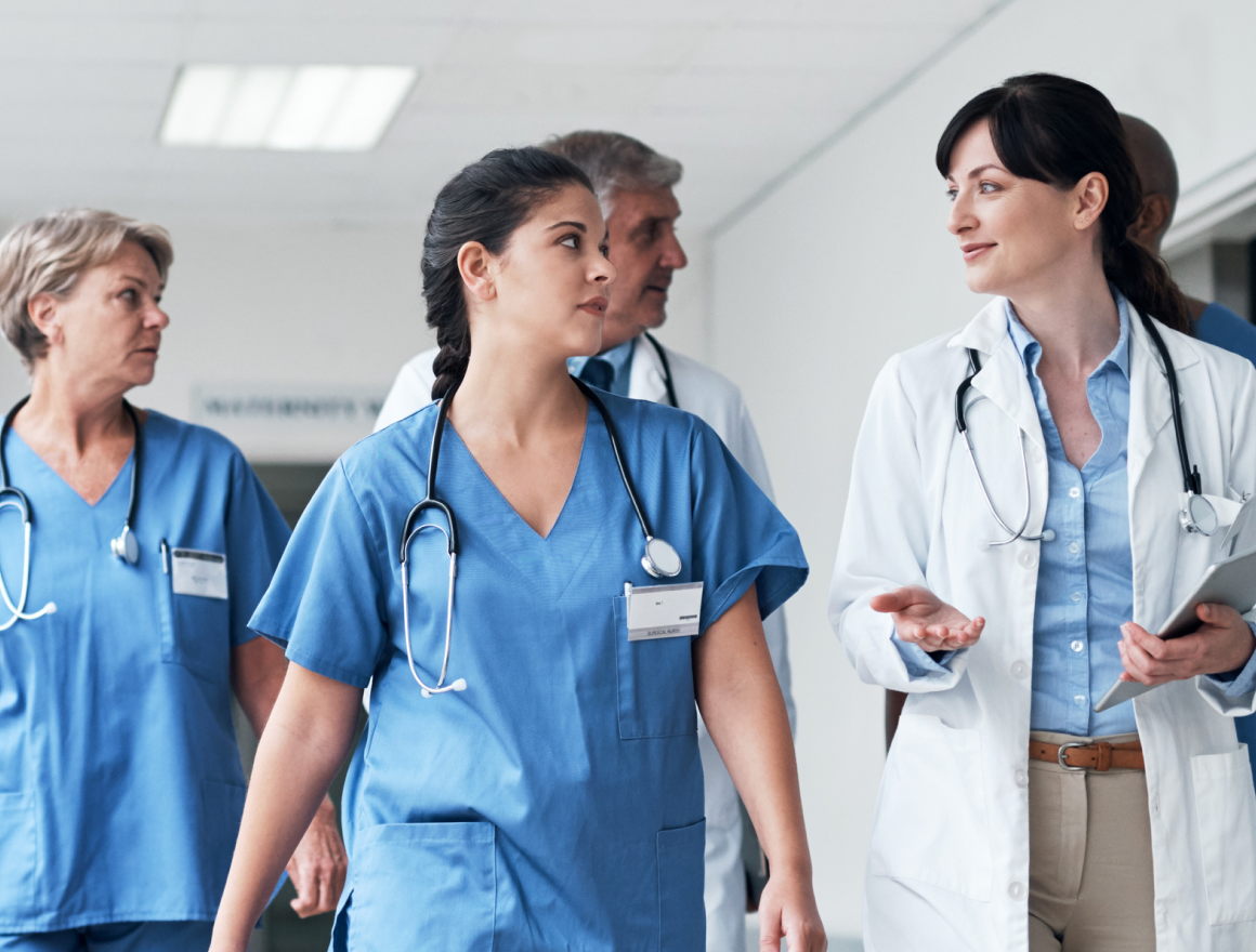 healthcare professionals walk together in a hospital setting